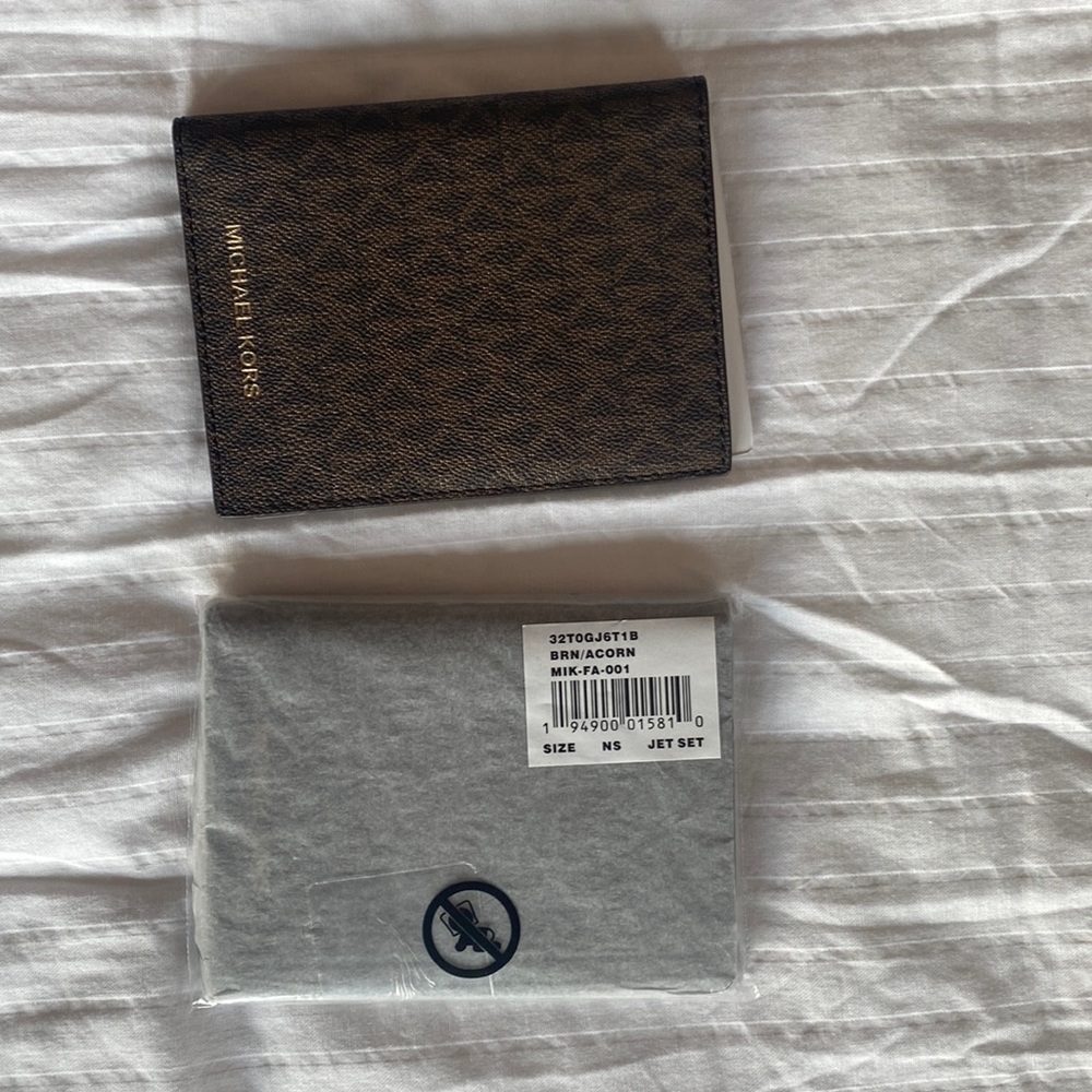 Two Michael Kors passport holders! Never used and still in wrapping!!